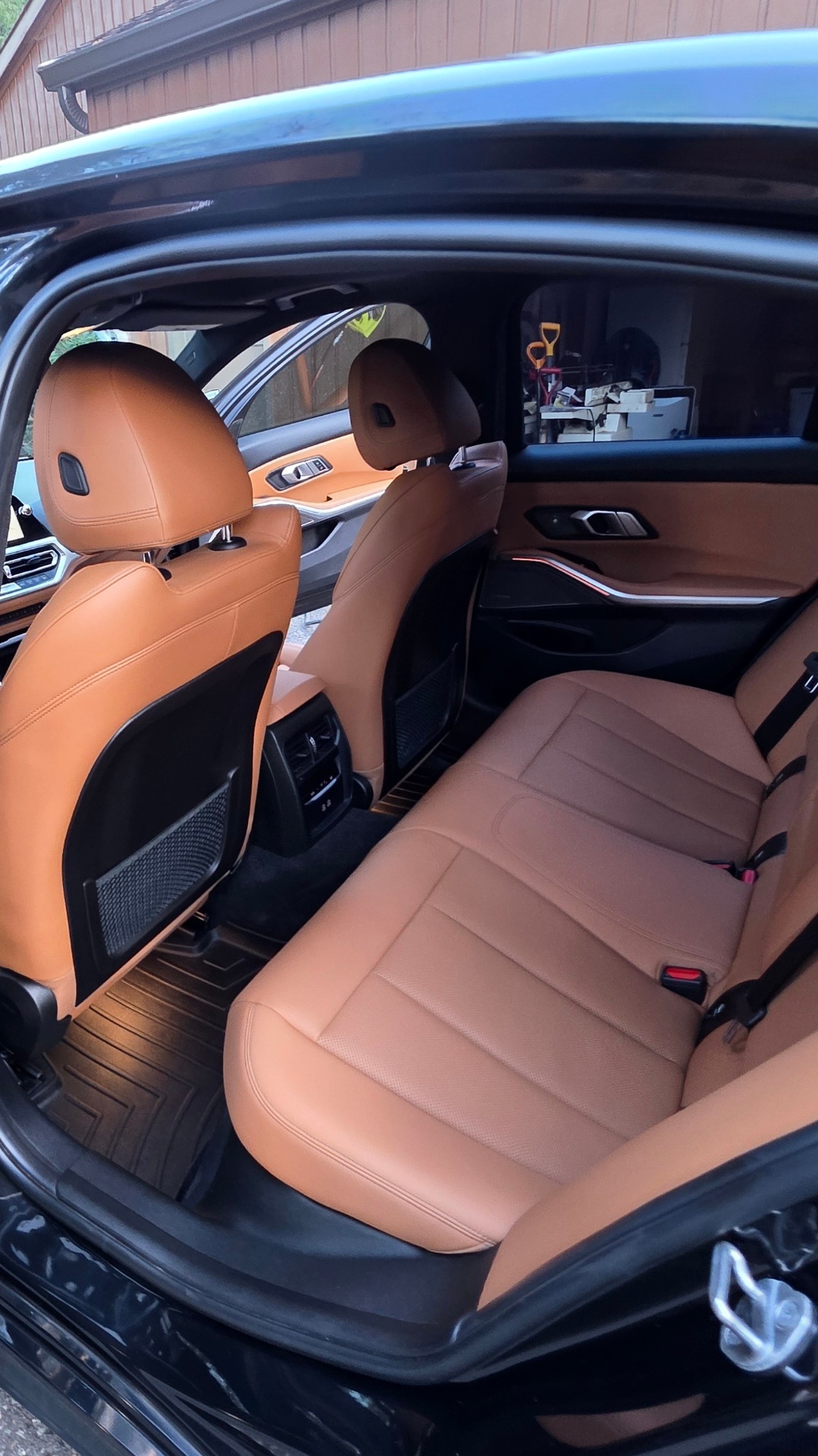 Rear cabin with cognac leather seats and climate vents detailed